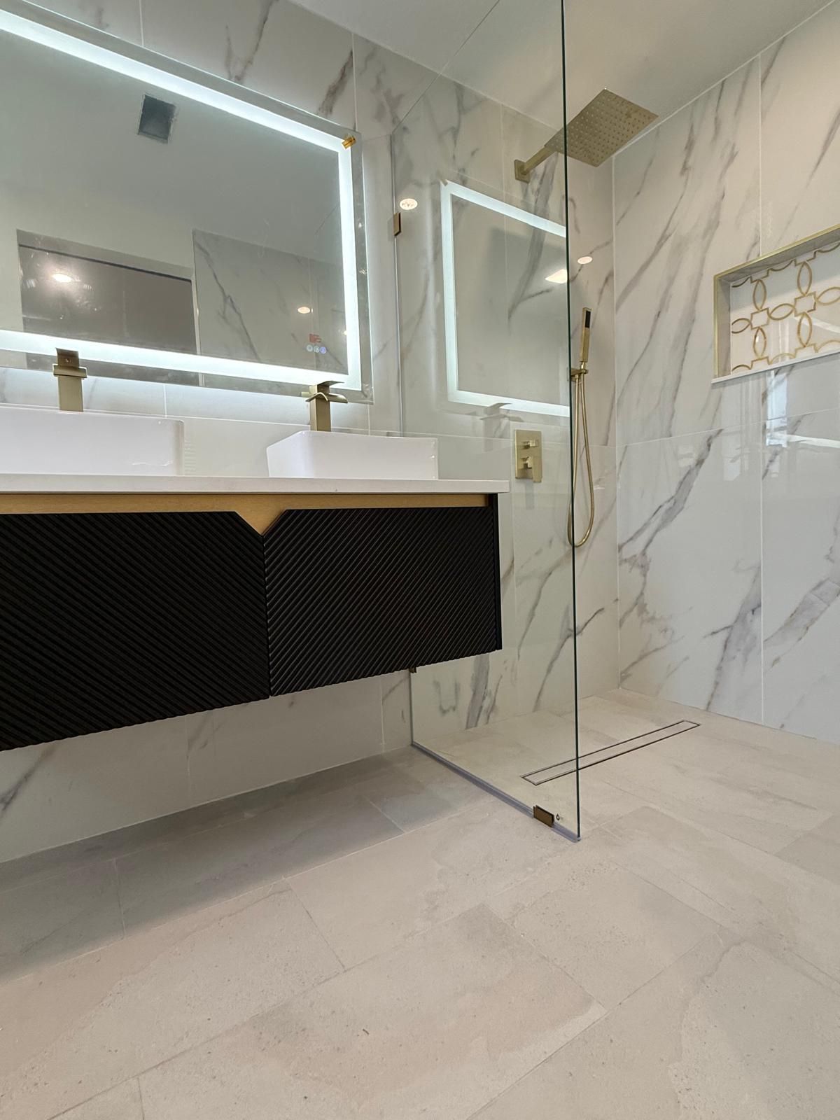 Double floating vanity with LED mirrors and a frameless glass walk-in shower