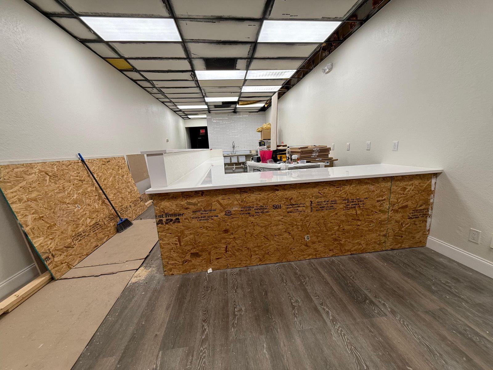 Commercial build-out with a new quartz-topped service counter under construction